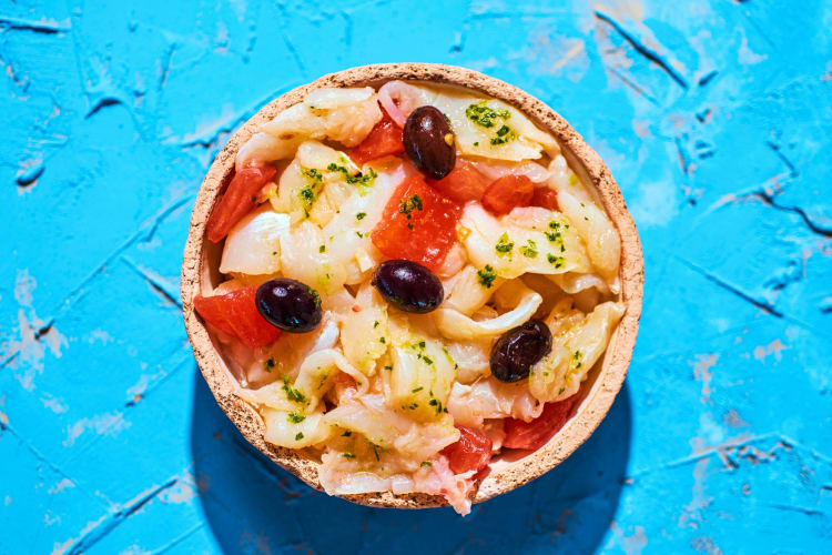 This Barcelona food is made with shredded salt cod (bacalao) combined with ripe tomatoes, onions, black olives and a drizzle of extra virgin olive oil.