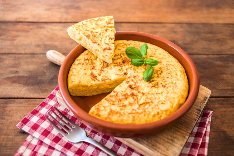 This Barcelona food features thinly sliced potatoes and onions cooked in olive oil, then mixed with beaten eggs and cooked into a fluffy, savory omelet. 