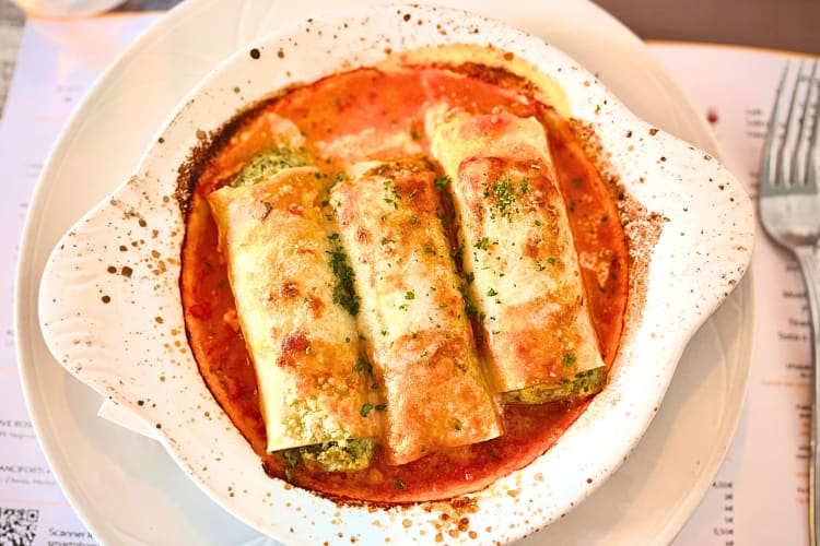 This Barcelona food features pasta tubes stuffed with leftover stewed meat.