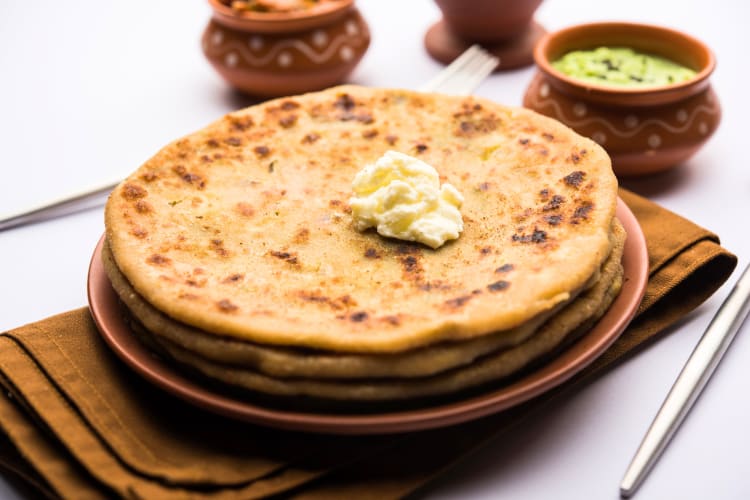 A thinner flatbread than naan, parathas are like flexible tortillas that can cradle other North Indian foods.