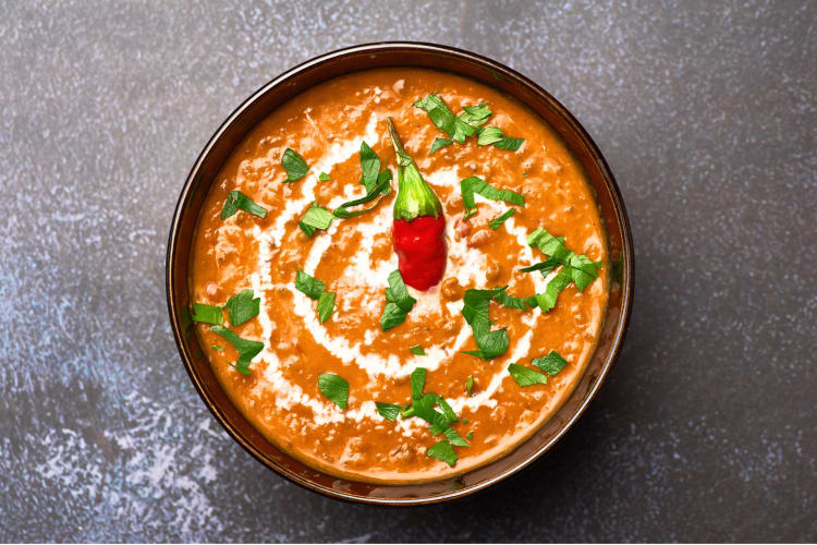 This North Indian dish includes black lentils float in sauce made of butter and cream topped with herbs and spices.
