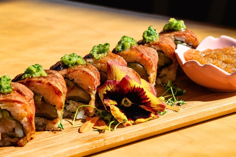 Sushi with a saucer of side sauce from Aya Sushi