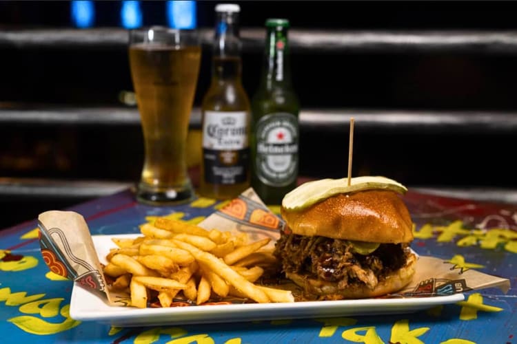 Burger and fries with drinks in the background, from B.B. King’s Blues Club