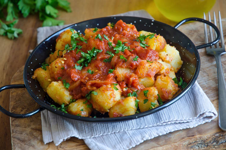 Patatas bravas in a black pan