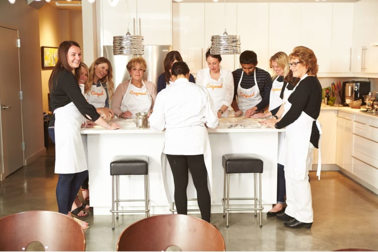 a group of women attend a cooking class together