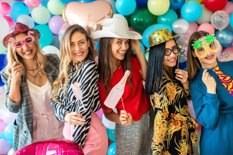 Women dressed up with photo booth props