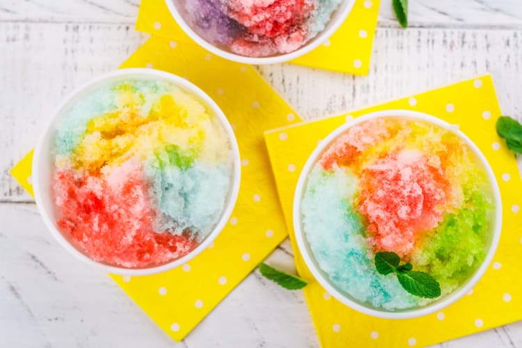 Colorful shave ice on yellow napkins