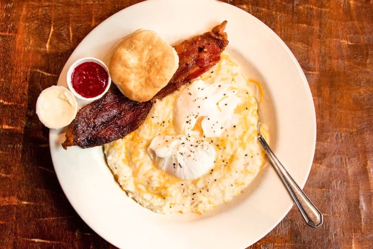 Aerial shot of a meal from BACON with eggs, bacon, a scone and sauces