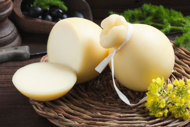 Spherical caciocavallo cheese on a woven mat