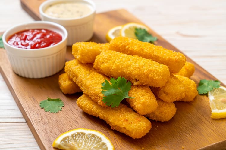 Breaded fish strips served with ketchup and tartare sauce