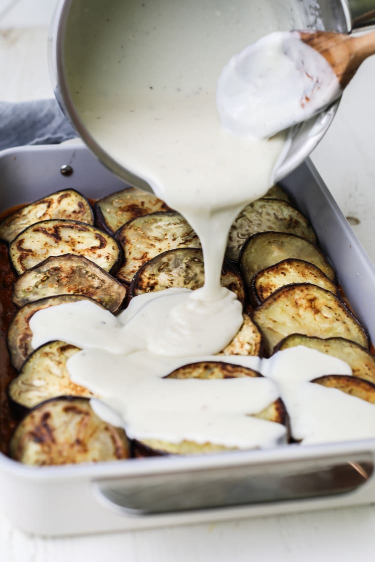 bechamel sauce poured over eggplant