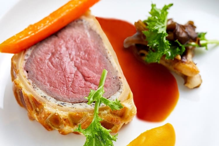  Beef Wellington, carved table-side for two to share with hen-of-the-woods mushroom and glazed carrot.