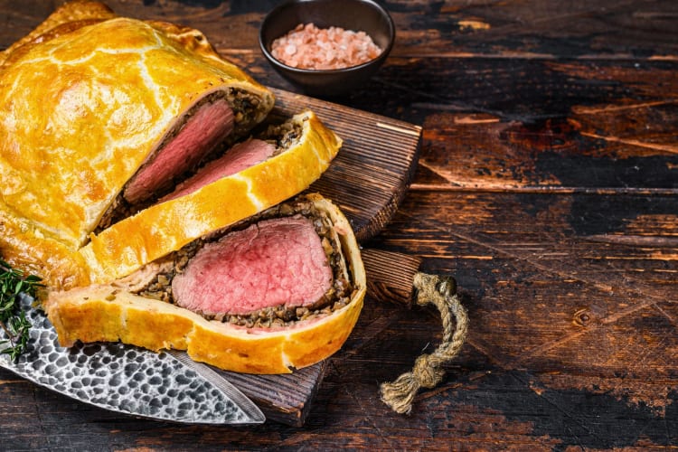 Homemade beef Wellington encased in puff pastry.