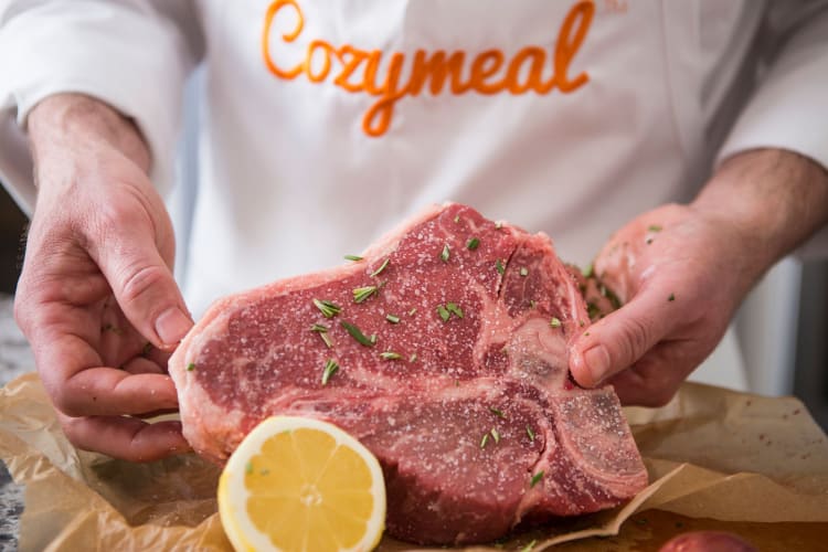 A chef preparing meat to cook