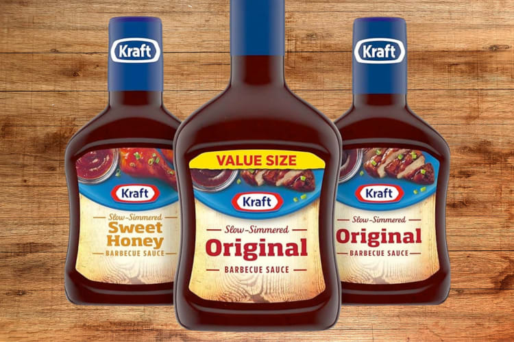 Three bottles of Kraft barbecue sauce on a wooden background