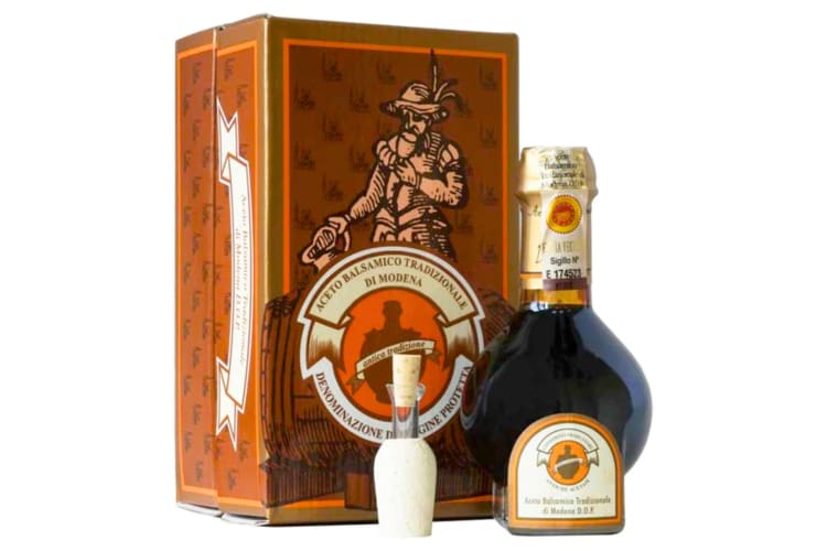 A bottle of balsamic vinegar next to its box 