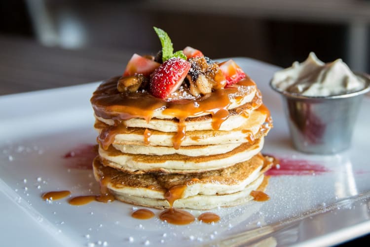 Fluffy pancakes served on a plate.