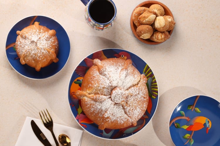 An aerial view of baked goods and coffee on patterned plates