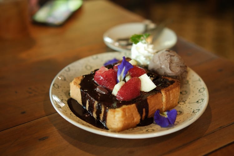 French toast with chocolate sauce and berries on a plate