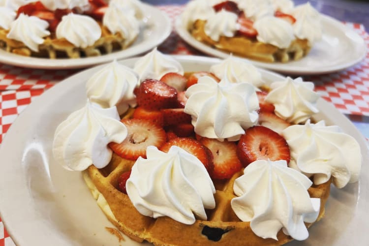 Waffles with strawberries and whipped cream