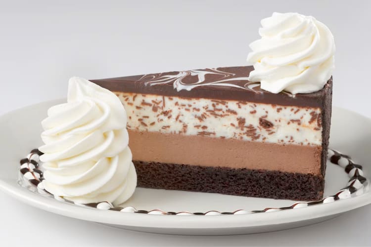 A slice of cheesecake with three layers
