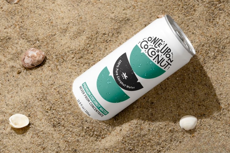 A can of coconut water in the sand