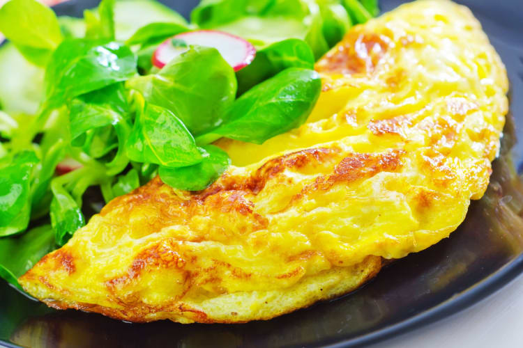 An egg omelette with leaves to garnish.