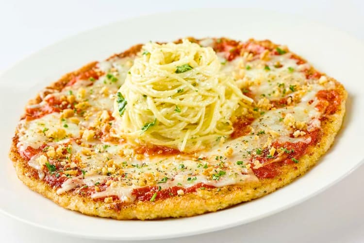 A pizza-shaped chicken Parm with spaghetti on top
