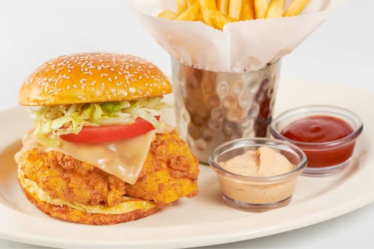 A crispy chicken sandwich, fries and two dipping sauces
