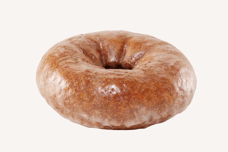 A pumpkin ring donut with glaze