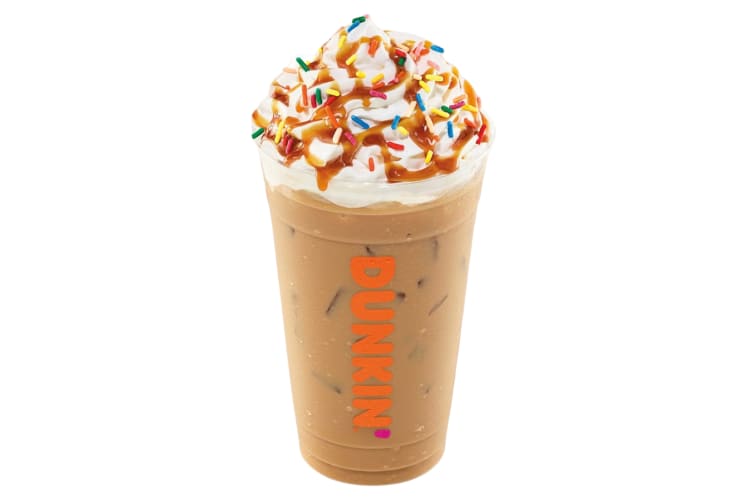 An iced coffee drink with whipped cream and sprinkles