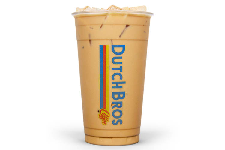 A milky iced coffee beverage in a clear cup