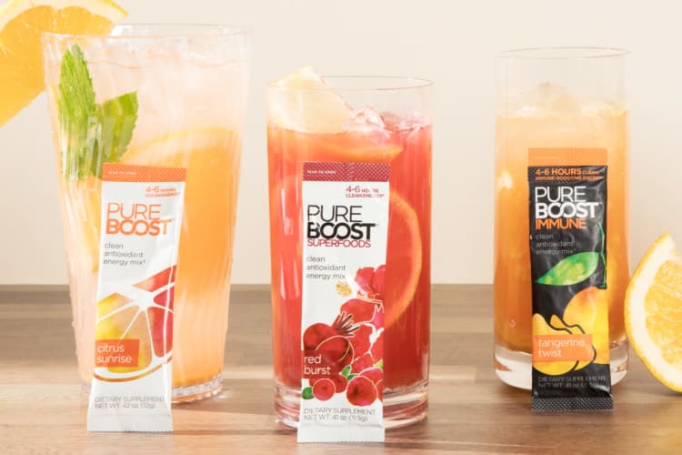 Three beverages next to packets of Purenboost