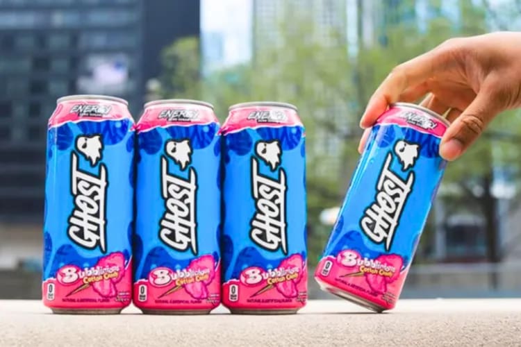 Pink and blue ghost energy drinks on a wall
