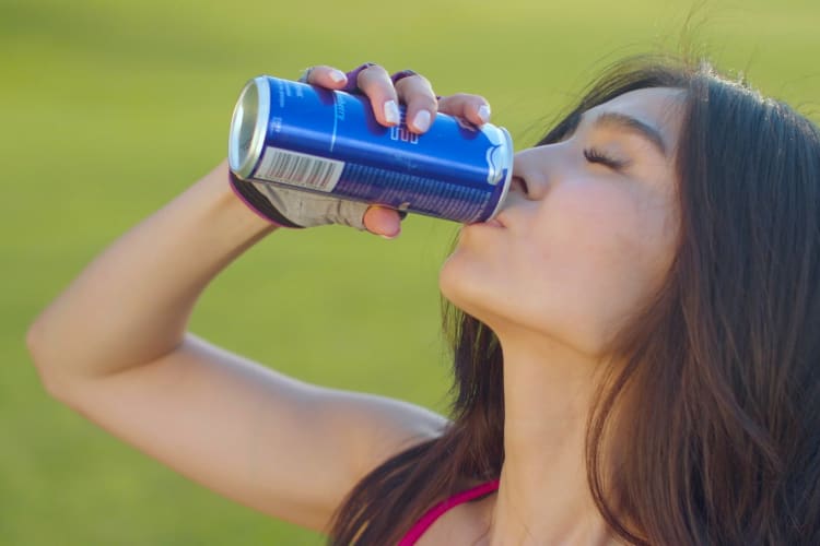 A woman drinking an energy drink