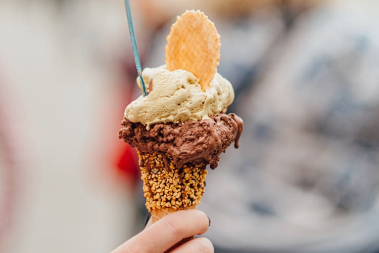A person holding a cone with gelato