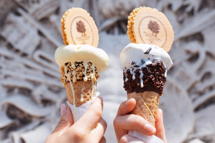 Two people holding cones with gelato
