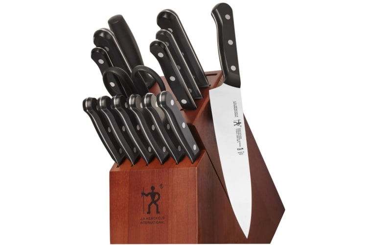 A wooden knife holder with knives in it