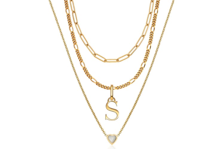 A three chain gold necklace with a white stone and a letter s charm