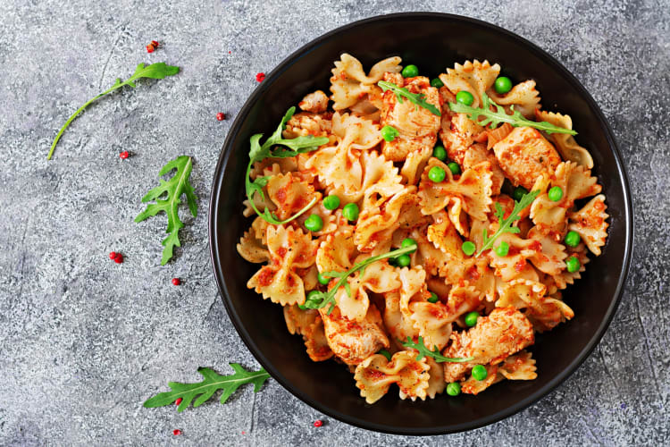 A pasta dish with chicken and tomato sauce
