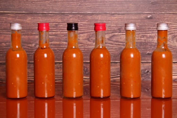 Small glass bottles of hot sauce