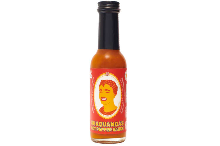 An orange bottle of Shaquanda Will Feed You Hot Pepper Sauce