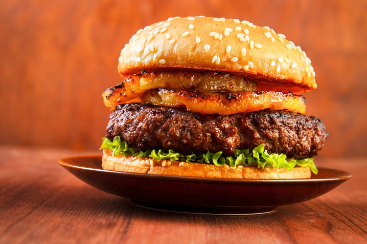 Close-up eye-level shot of a burger on a plate