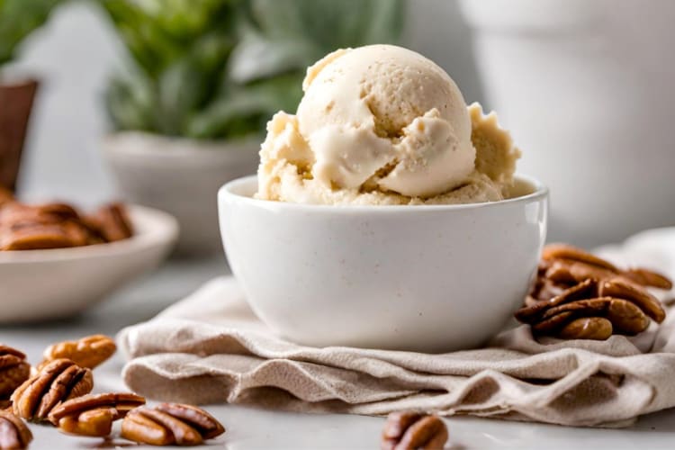 A bowl of ice surrounded by pecans