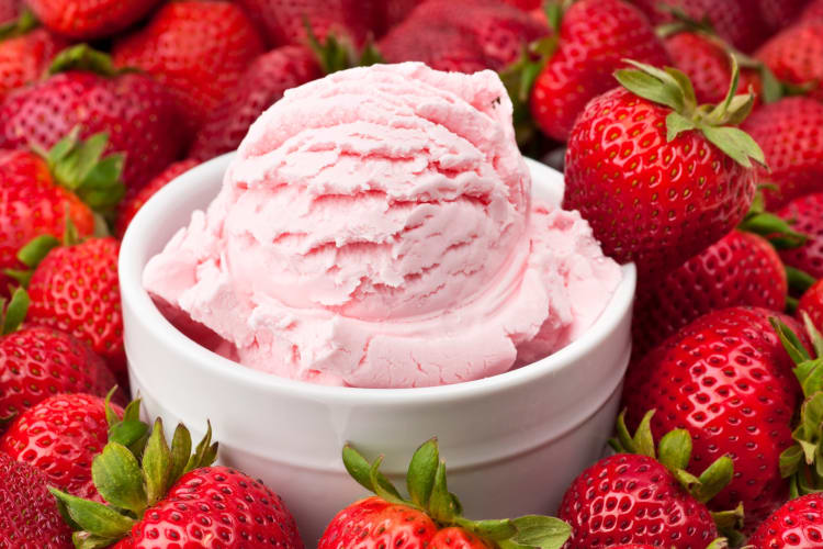 Strawberry ice cream surrounded by fresh strawberries