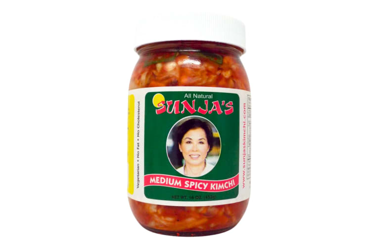 A jar of kimchi with a woman's face on the label