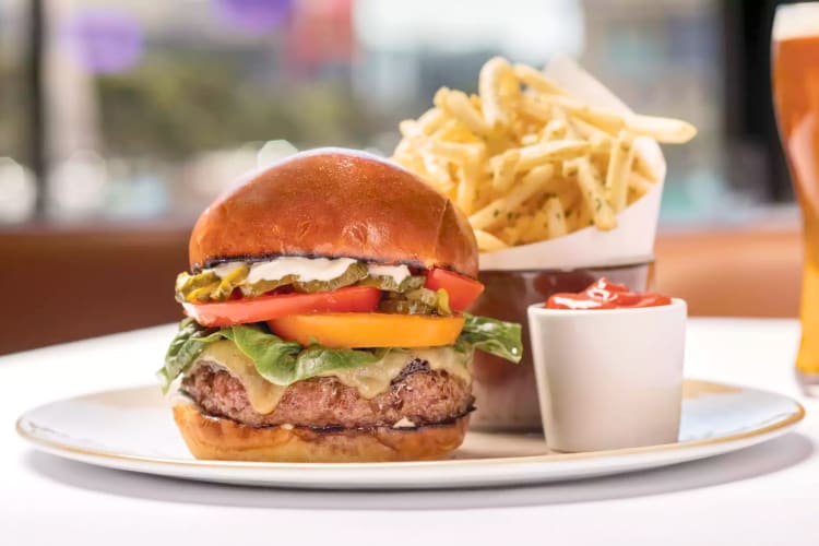  Fries and a cheeseburger with tomatoes, pickles and lettuce