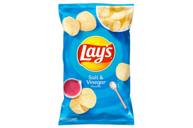 A blue bag of salt and vinegar lays chips