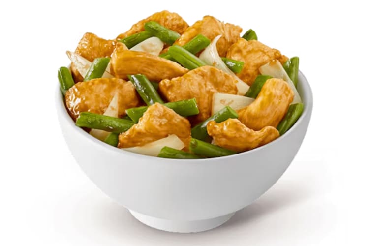 A bowl of chicken, onion and green bean stir-fry