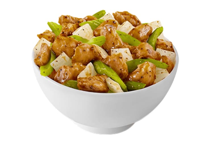 A bowl of black pepper chicken with celery and onions